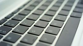 Nahaufnahme einer Laptop-Tastatur mit schrägem Blickwinkel, Fokus auf den Buchstabentasten.